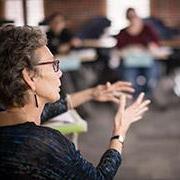 Teacher in a classroom talking with her hands